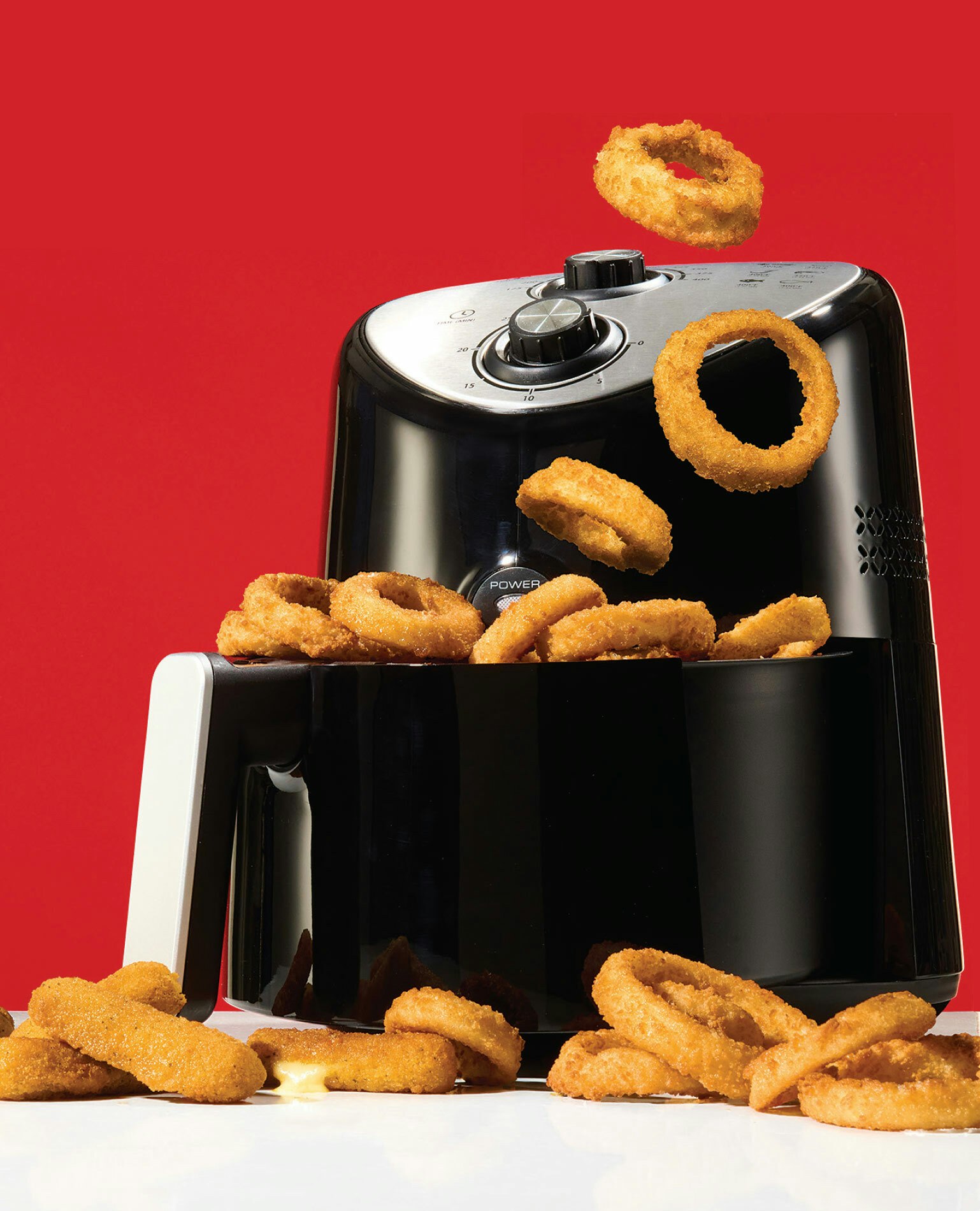 Hot air fryer with onion rings spilling out
